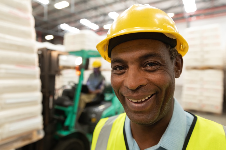 male worker smiling at a warehouse